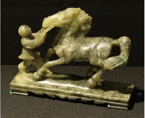 A Chinese jade coloured hardstone carving of a horse and figure, 19cm long 