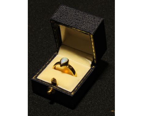 A 9ct gold ring set with a single tear drop shaped polished opal cabochon, 4.4g, boxed 