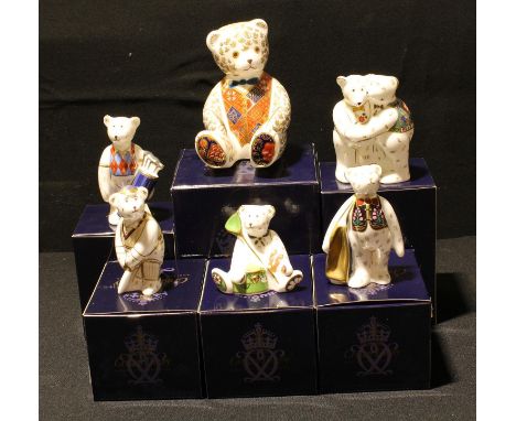 A Royal Crown Derby paperweight, Teddy Bear, gold stopper, boxed; other Royal Crown Derby Teddy Bear models, On The Tee Golfe