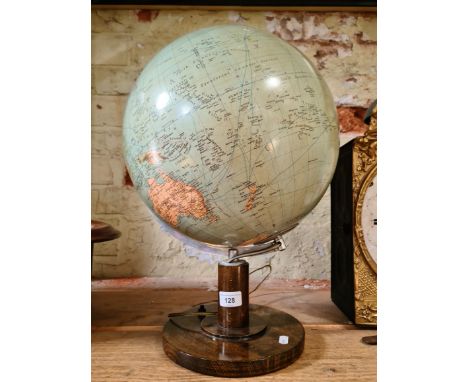 A glass spherical light globe with chrome support, on wooden base.  