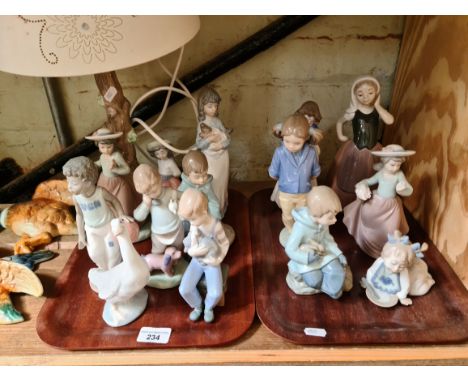 A group of 14 Nao figures to include table lamp.  