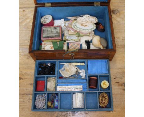 A Victorian rosewood sewing box with mother of pearl inlay and key, containing haberdashery items including a shell pin cushi