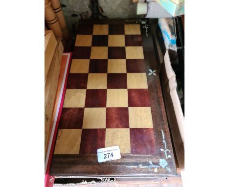 An Oriental chess board, having mother of pearl inlay on corners and 2 interior compartments, complete with stone figures.  