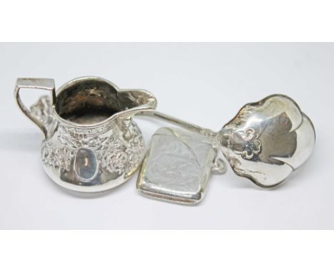 A group of silver items including a small ladle spoon, a small jug and a vesta case, gross weight 78.25 grams.  
