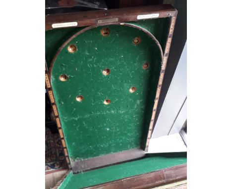 A 19th century green baize lined bagatelle board labelled 'Thomas Agnew, Manchester'.  
