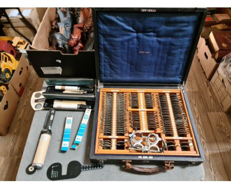 A fitted case containing a vintage optical set from the 30's and a collection of 70's related items to include 2 ophtalmoscop