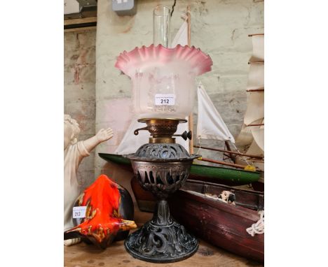 An oil lamp with glass shade and funnel.  