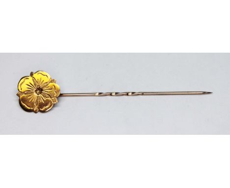 A rosette stick pin marked '9ct', wt. 1.4g, length 61mm.  