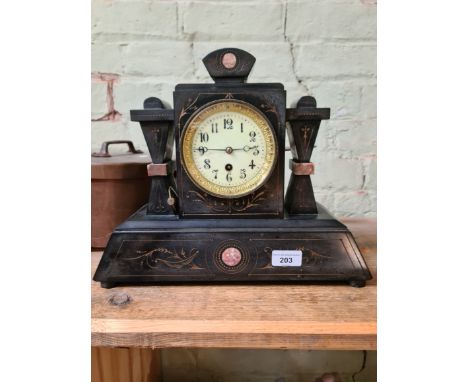 A Victorian black slate mantel clock with enamelled face, gilt rim and pendulum.  
