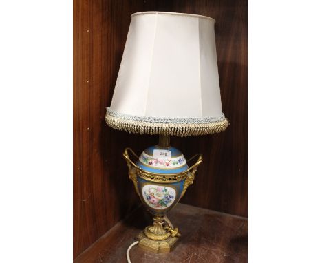A CONTINENTAL HAND PAINTED TWIN HANDLED CERAMIC AND BRASS TABLE LAMP DECORATED WITH FIGURES AND FLOWERS OVERALL HEIGHT INC SH