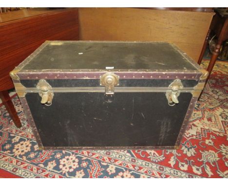 A VINTAGE BLACK PACKING TRUNK