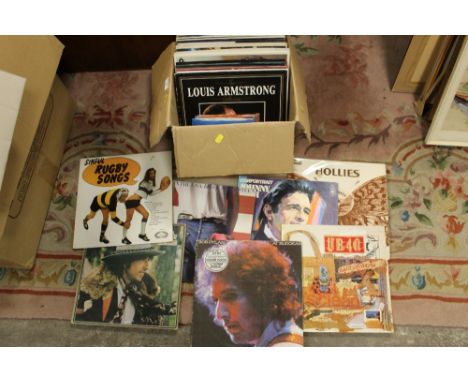 A BOX OF LP RECORDS AND SINGLES TO INCLUDE THE HOLLIES, UB40, BOB DYLAN ETC 