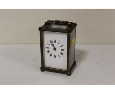 A VINTAGE BRASS AND GLASS CARRIAGE CLOCK 