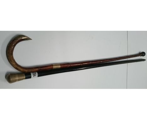 An early 20th century walking cane with engine turned silver knop together with a silver mounted walking stick.