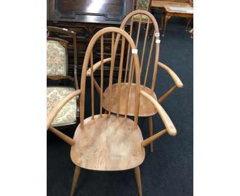 A pair of matching elm seated stick back Ercol Windsor chairs.