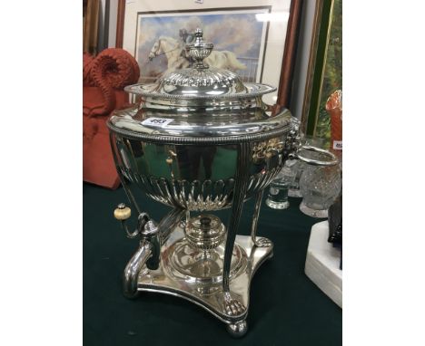 A silver plated urn shaped Samovar resting on paw feet with lion mask ring handles and small urn finial to lid.