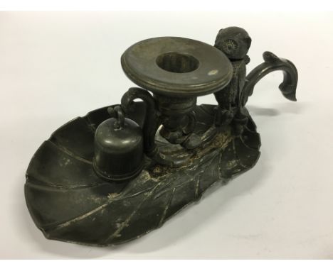 An Arts & Crafts style pewter chamber stick with Owl match holder and bell shaped snuffer.