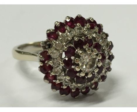 An 18 carat gold ruby and diamond cluster ring (af - missing two ruby stones).