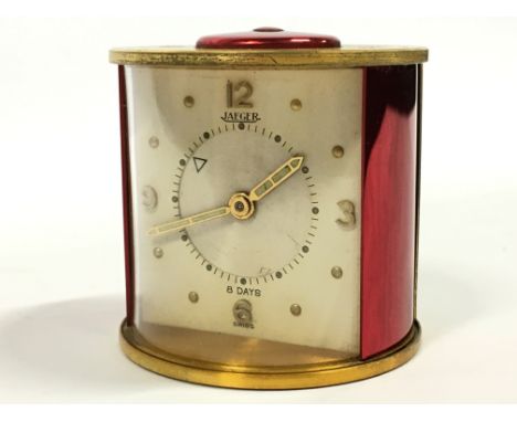 A Jaeger 8 day travelling alarm clock, gold plated (af).