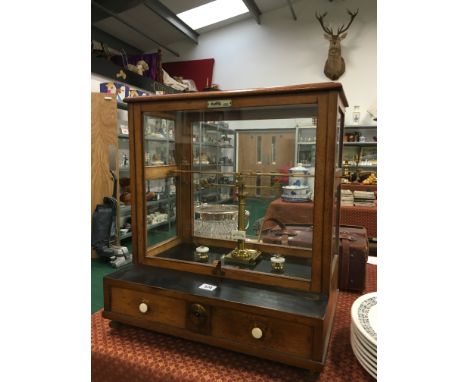 An early 20th century Oertling set of brass chemist scales in original glazed cabinet with two drawers under and original tur