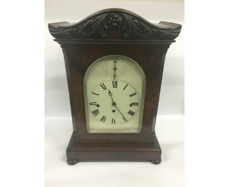 A 19th century flame mahogany cased large bracket clock with pierced floriate panels to sides and rear, white painted metal d