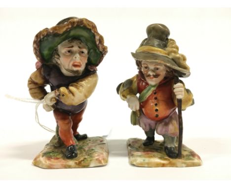 A pair of Naples Capo Di Monte dwarf figures modelled as Dwarf Hunchbacks, a man drawing a dagger in wide brimmed hat togethe