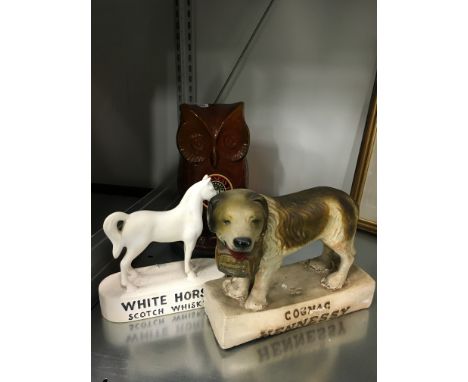 A Guinness 1980 glass Owl shaped LV & H collecting money box on plastic stand together with a small white horse Scotch Whisky