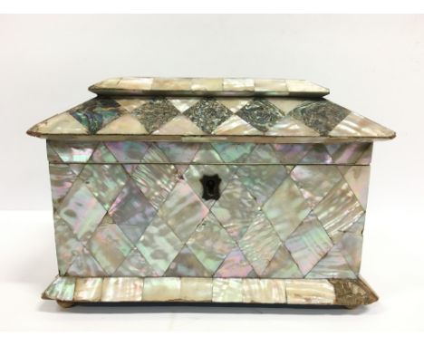 A 19th century Mother of Pearl covered tea caddy with double lidded fitted interior and minor losses.