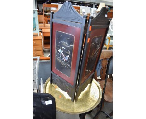 An oriental folding two panel fire screen, ebonised frame with mother of pearl inlaid panels, height approx. 74cm