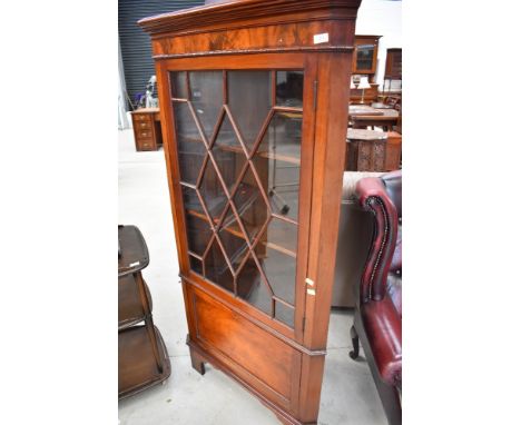 An Edwardian mahogany full height corner display cabinet having astral glazed top with cupboard base and bracket feet, width 