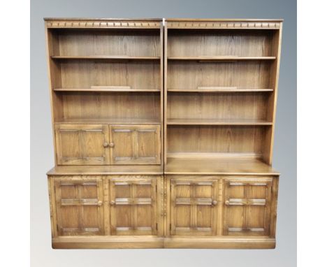 An Ercol stained elm three section wall unit, length 294 cm