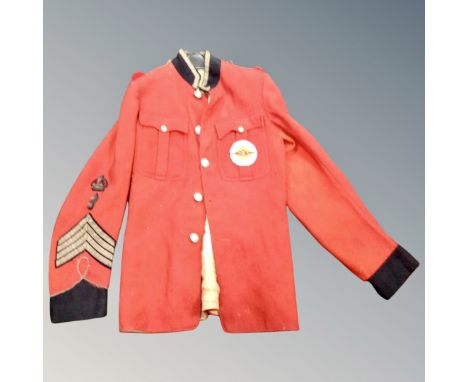 A British Army formal military tunic bearing Stg. Pepper's Lonely Hearts Club Band sew on badge 