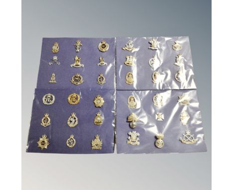 Thirty-six British Army cap badges mounted on card 