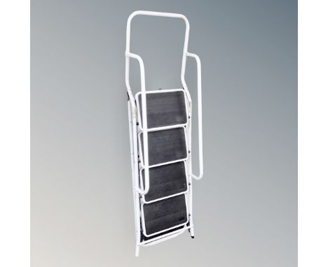 A four tread folding step ladder with double hand rail 