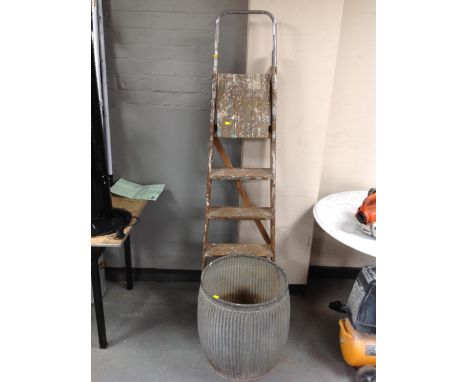 A vintage galvanized wash tub together with a set of folding wooden step ladders 