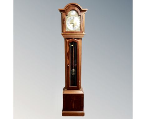 A reproduction longcase clock with brass and silvered dial signed Thomas Byrne, with pendulum and weights 
