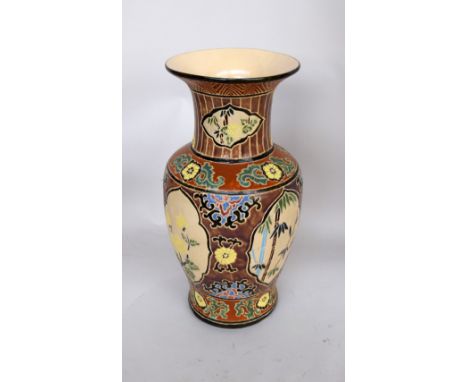 A large orinetal style ceramic vase of brown, orange, blue and black glaze over cream ground 53cmH