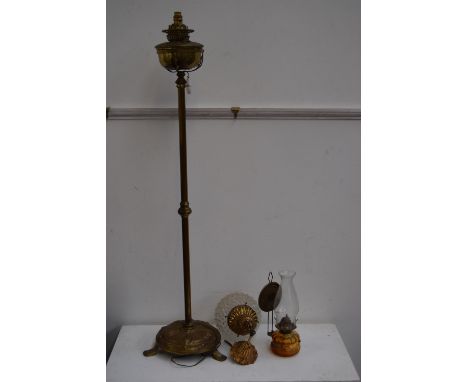 A brass floor standing oil lamp (later adapted for electricity) together with a pendant wall light with moulded glass shade a