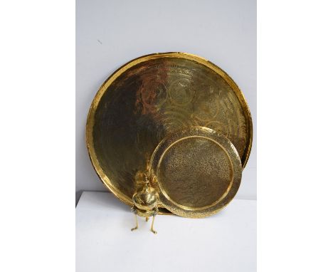 An Indian brass circular tea tray, an Islamic brass censor and cover of dome form with engraved calligraphy, a wall hanging s