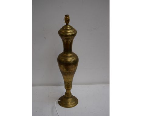 A brass incised lamp base with bands of foliate design 64cmH