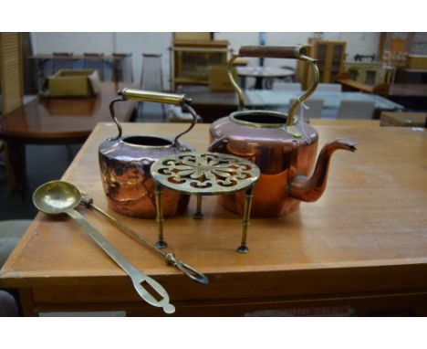 Two 19th century brass and copper kettles, brass ladels and toasting fork and candlestick together with three brass trivets a