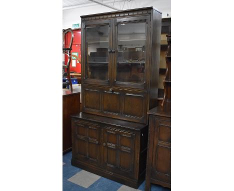 A Mid 20th Century Ercol Oak Bookcase with Pull Down Cocktail Section to Centre, 98cm wide 
