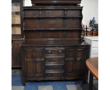 An Ercol Dresser the Base with Four Centre Drawers Flanked by Cupboards, Raised Two Shelf Plate Rack, 144cm wide 