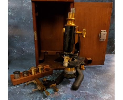 An Edwardian brass and cast iron microscope, marked Makers R&nbsp; &amp; B Ltd Leeds, with accessories, fitted mahogany case 