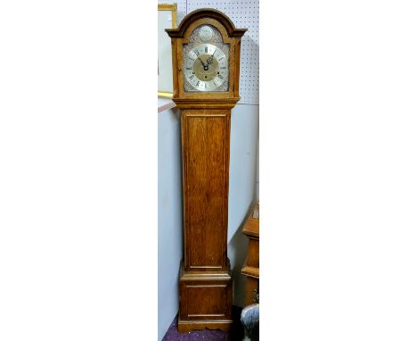 See All Images - An early 20th century oak grandmother clock, the brass arched dial, with pierced foliate spandels, Roman num