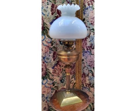 A Young's patent oil lamp, frosted Hassop shade above polished brass reservoir, turned fluted column with topped base, standi