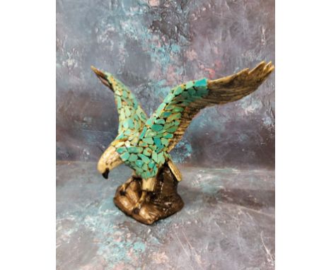 A Duncan Enterprises Company ceramic eagle, perched with wings outstretched, applied with turquoise shards, 39cm wide 