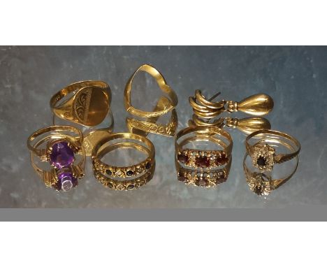 A 9ct gold gypsy ring set with three round garnets, size M 1/2, 1.94g gross; a 9ct gold half eternity ring set with four roun