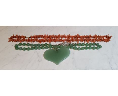 A Chinese jade bead necklace, heart shaped pendant, 27cm long;&nbsp; a coral necklace (2) 