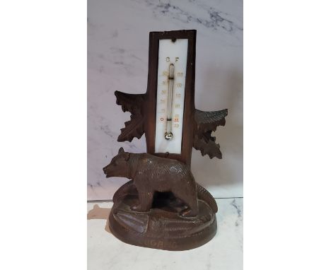 An early 20th century Black Forest thermometer, the base with a bear, inscribed Lugano, 18cm high, c.1900 